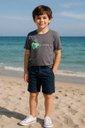 Boy wearing Key to My Heart boys edition casual t-shirt with heart and key print at the beach