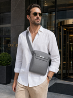 Man wearing the Sinclair grey sling bag in front of a hotel