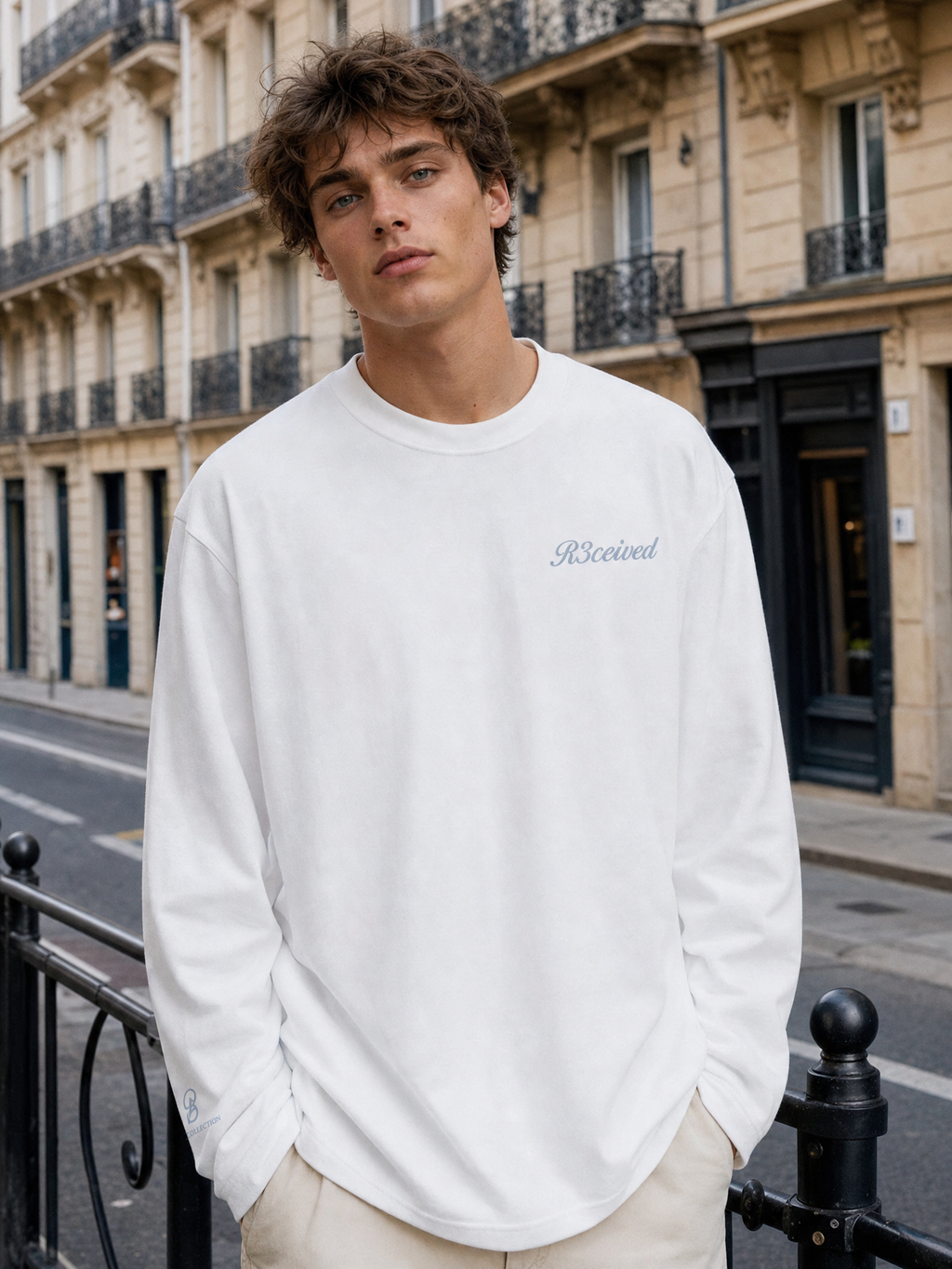 Granted in Style Long Sleeve wit - model draagt de voorkant met R3ceived logo op een Parijse straat