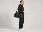 Aurelius Duffel Bag - worn crossbody, side view