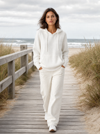 Gebreide hoodie wit - model loopt op strandboulevard