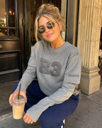 Female model wearing R3CEIVED 3:33 Long Sleeve (washed), candid outdoor shot