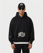 Model wearing the black Hustler Mid R3 hoodie by R3CEIVED, front view