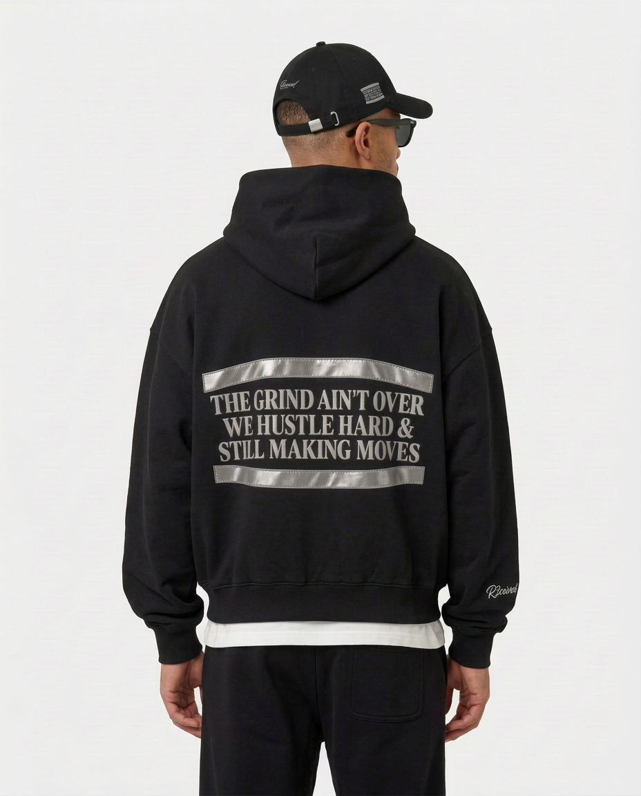 Back print of the black Hustler Mid R3 hoodie by R3CEIVED on model