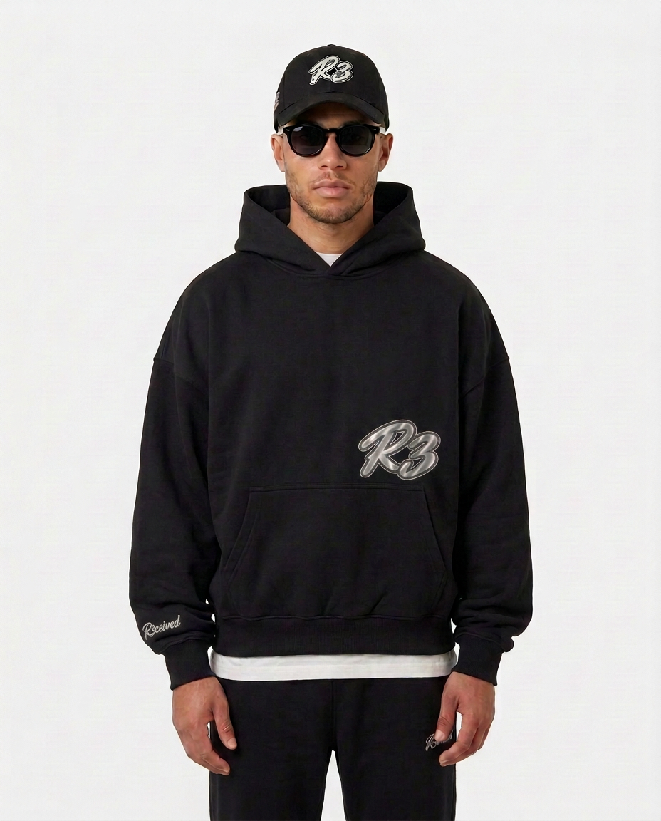 Model wearing the black Hustlers Classic Hoodie by R3CEIVED, front view