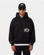 Model wearing the black Hustlers Classic Hoodie by R3CEIVED, front view