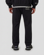 Back pocket print of the black Hustlers Jogger by R3CEIVED on model