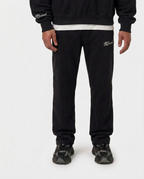 Model wearing the black Hustlers Jogger by R3CEIVED, front view
