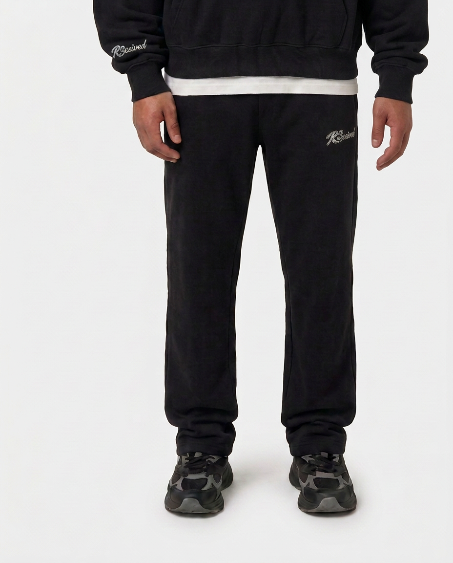 Model wearing the black Hustlers Jogger by R3CEIVED, front view