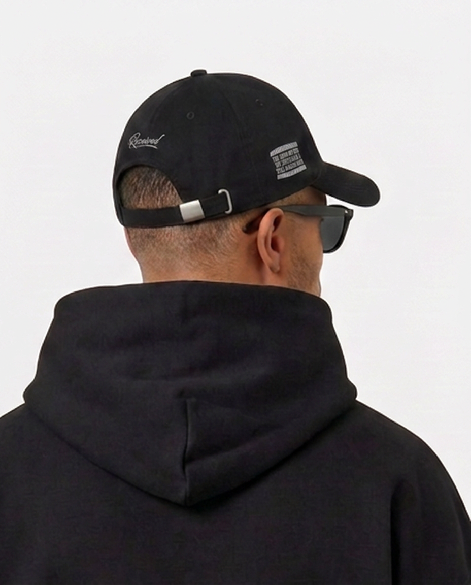 Back view of the black Hustlers Baseball Cap by R3CEIVED with buckle strap