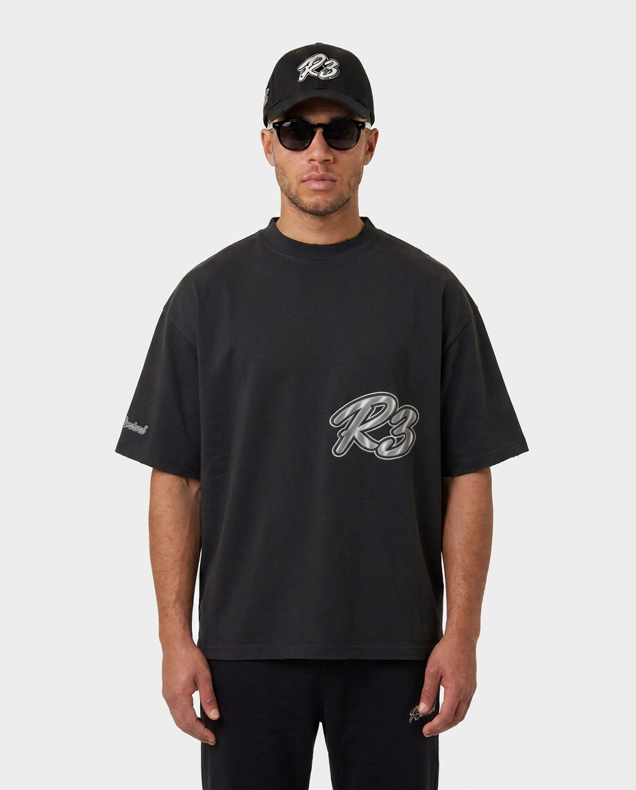 Model wearing the black Hustlers Washed Drop-Shoulder T-Shirt by R3CEIVED, front view