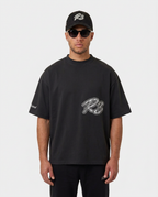 Model wearing the black Hustlers Washed Drop-Shoulder T-Shirt by R3CEIVED, front view