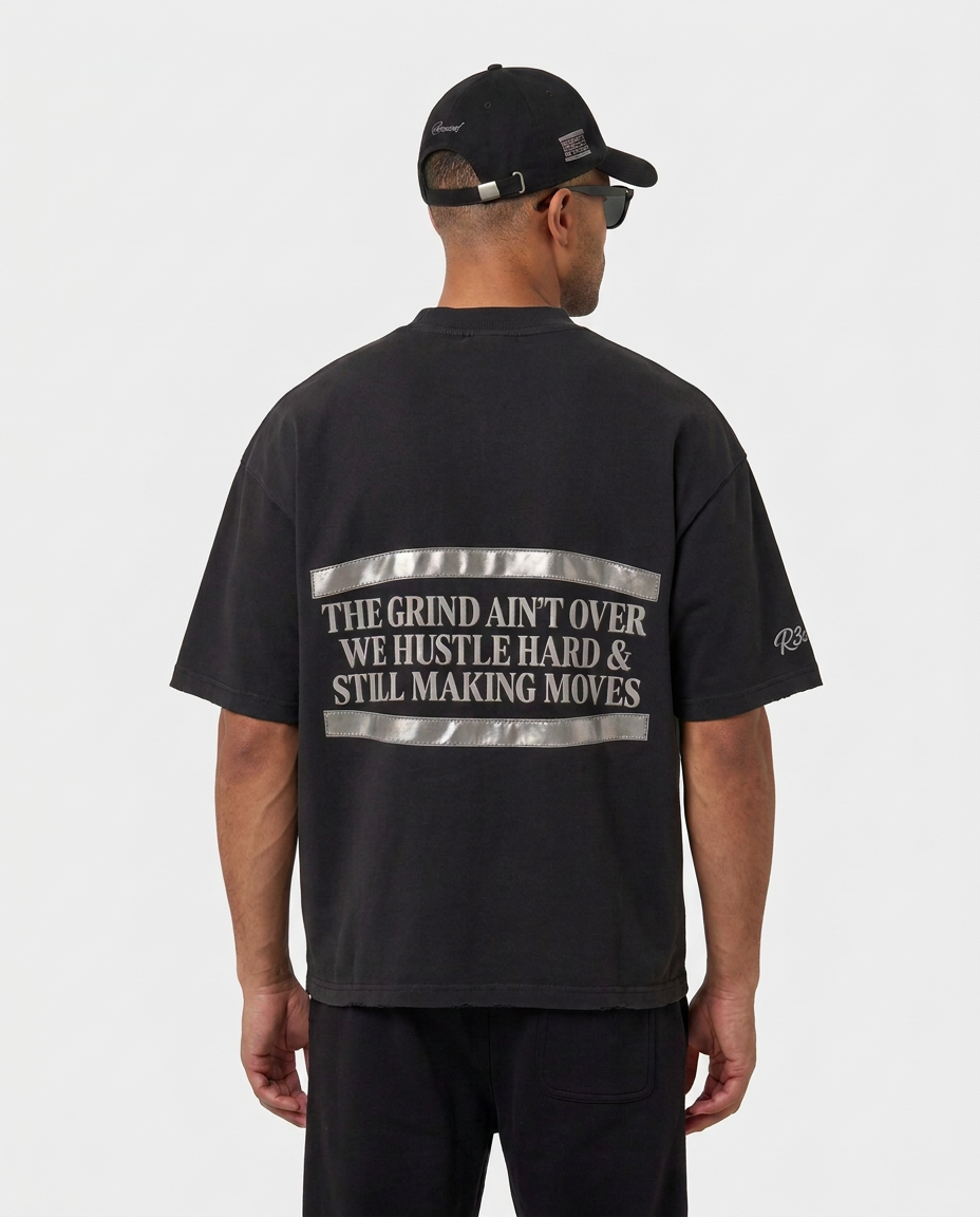 Back print of the black Hustlers Washed Drop-Shoulder T-Shirt by R3CEIVED on model