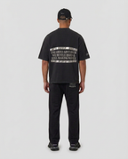 Full-body back view of the black Hustlers Washed Drop-Shoulder T-Shirt by R3CEIVED