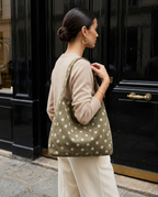 Close-up of the Polkadot Bag in Olive worn on the shoulder