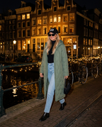 St. Moritz Maxi Coat in Army Green with R3 cap by an Amsterdam canal at night
